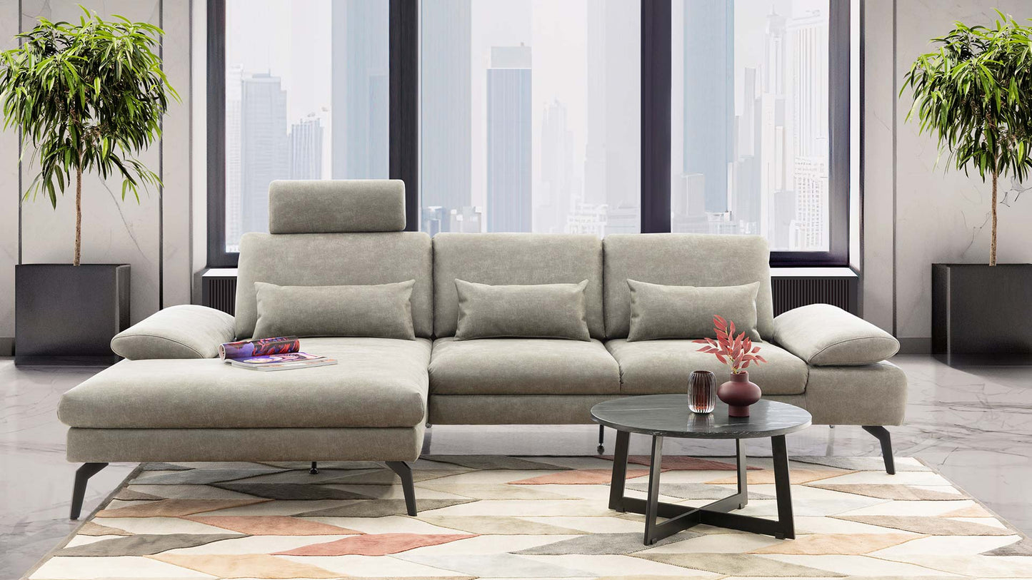 Modernes Ecksofa in grünem Stoff.