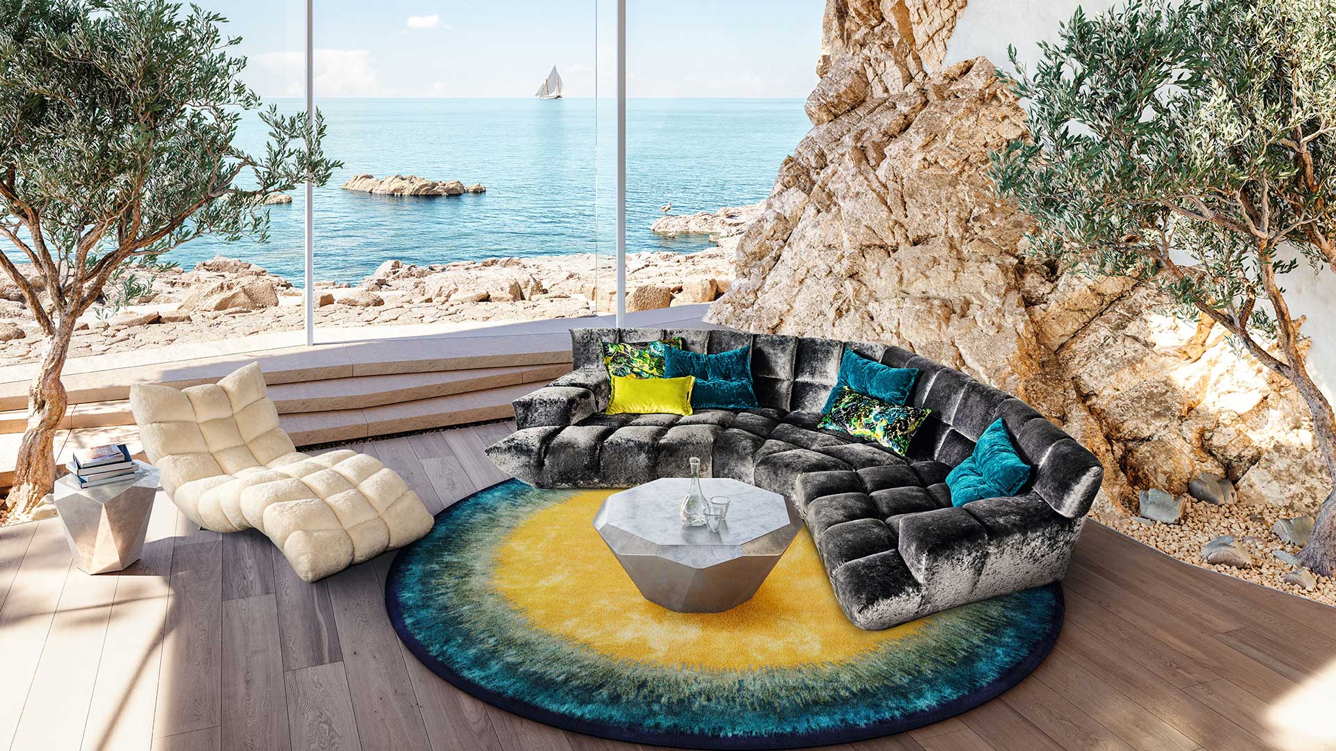 Bretz Cloud 7 Sofa in anthrazit-silbernem Velours mit Rautenmuster und eine Liege in beigem Velours in einem Wohnzimmer am Meer mit Glasfront.