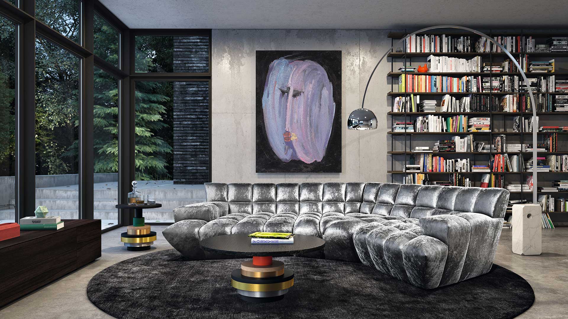 Großzügiges Wohnzimmer mit Bücherregal und Bretz Cloud 7 Sofa in einem grauen, silbernen Samtstoff.