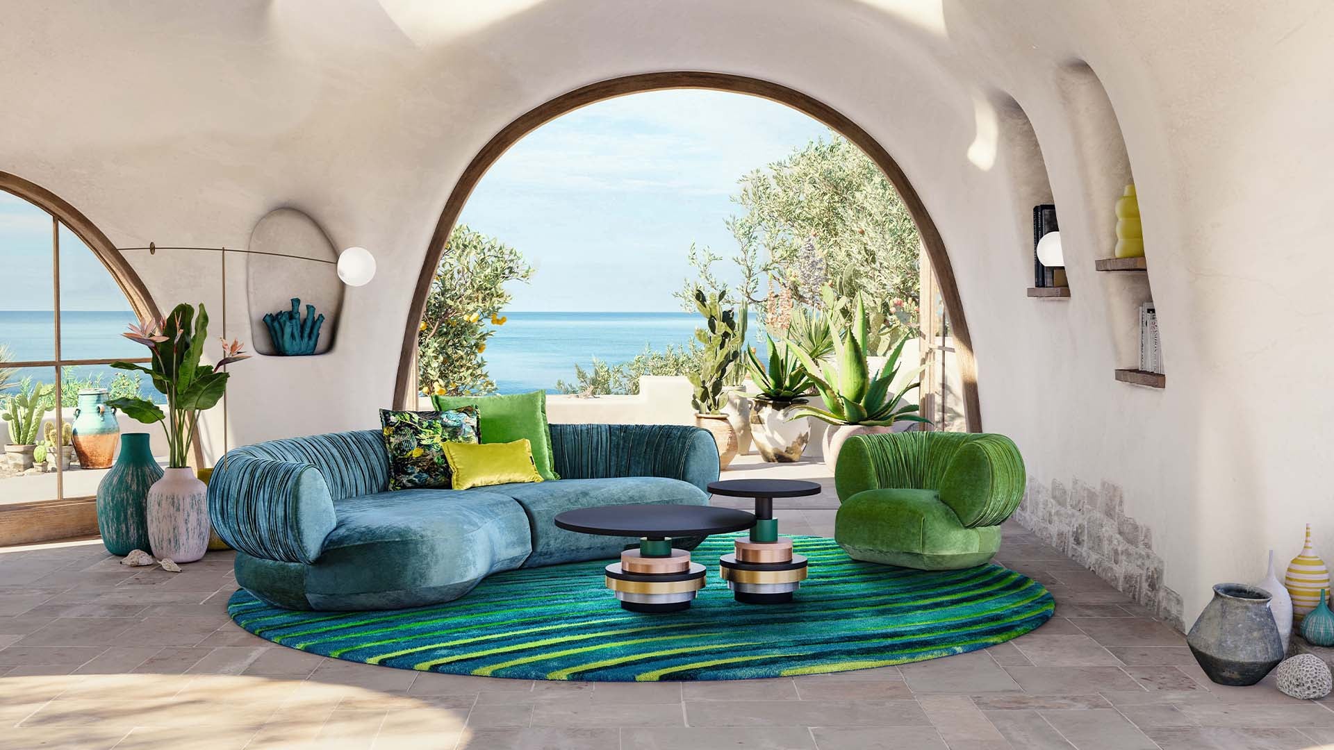 Gewölbtes Wohnzimmer am Meer mit Sofa und Bretz Sessel Nanami in grünem Samtstoff.