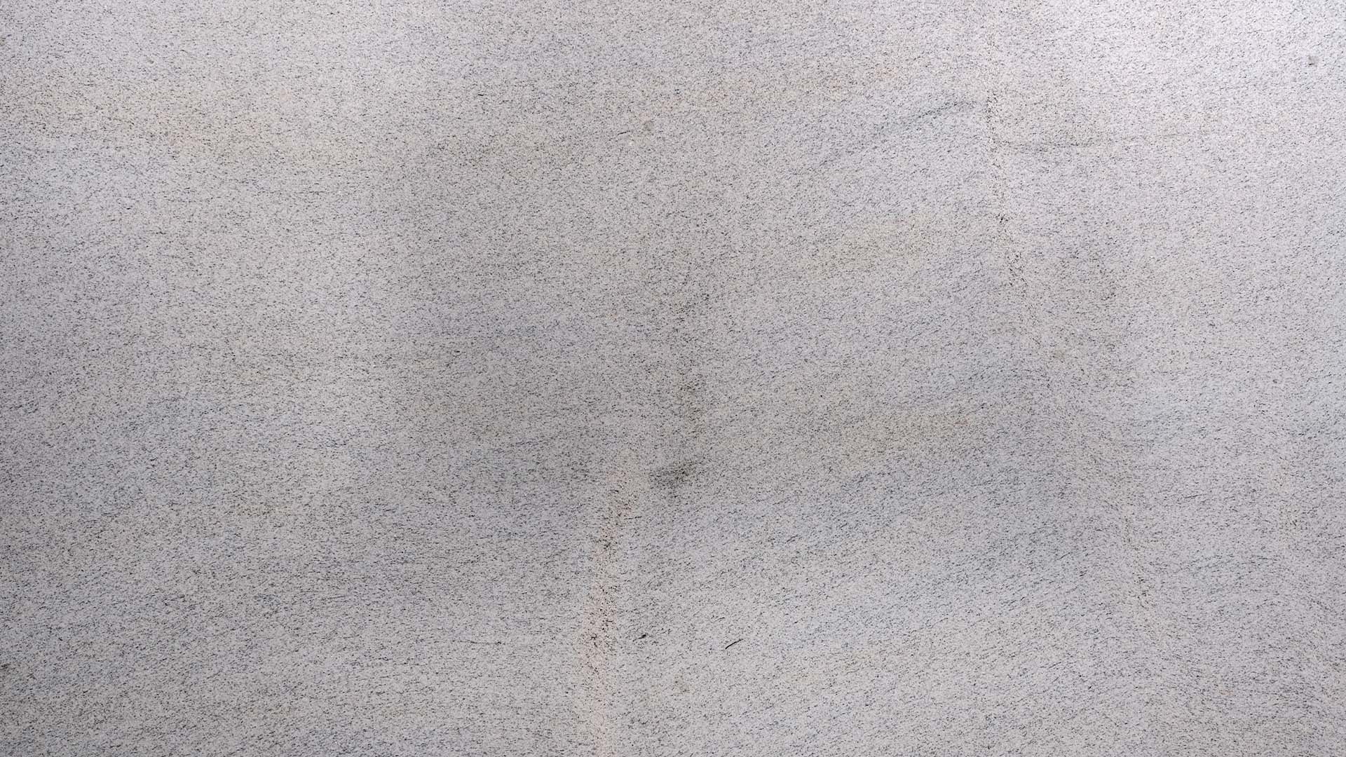 Naturstein Küchenarbeitsplatte in der Grundfarbe weiß mit dezenten schwarzen und bräunlichen Sprenklern im matten leather look in der Farbe Imperial White.